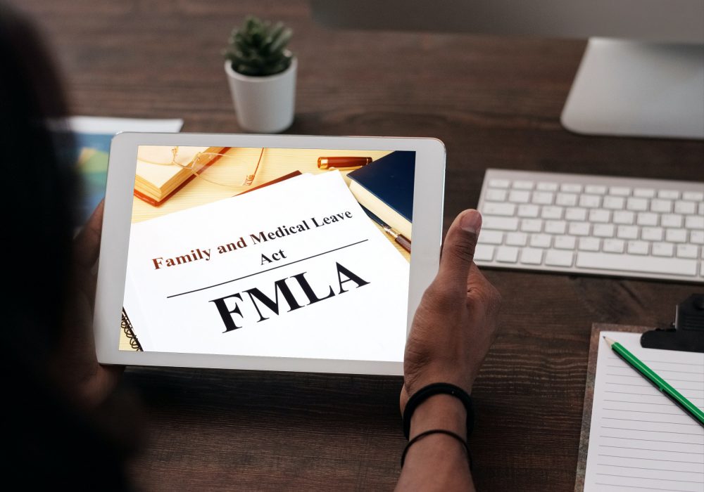 iPad in the hands of an African-American woman in the office_FMLA