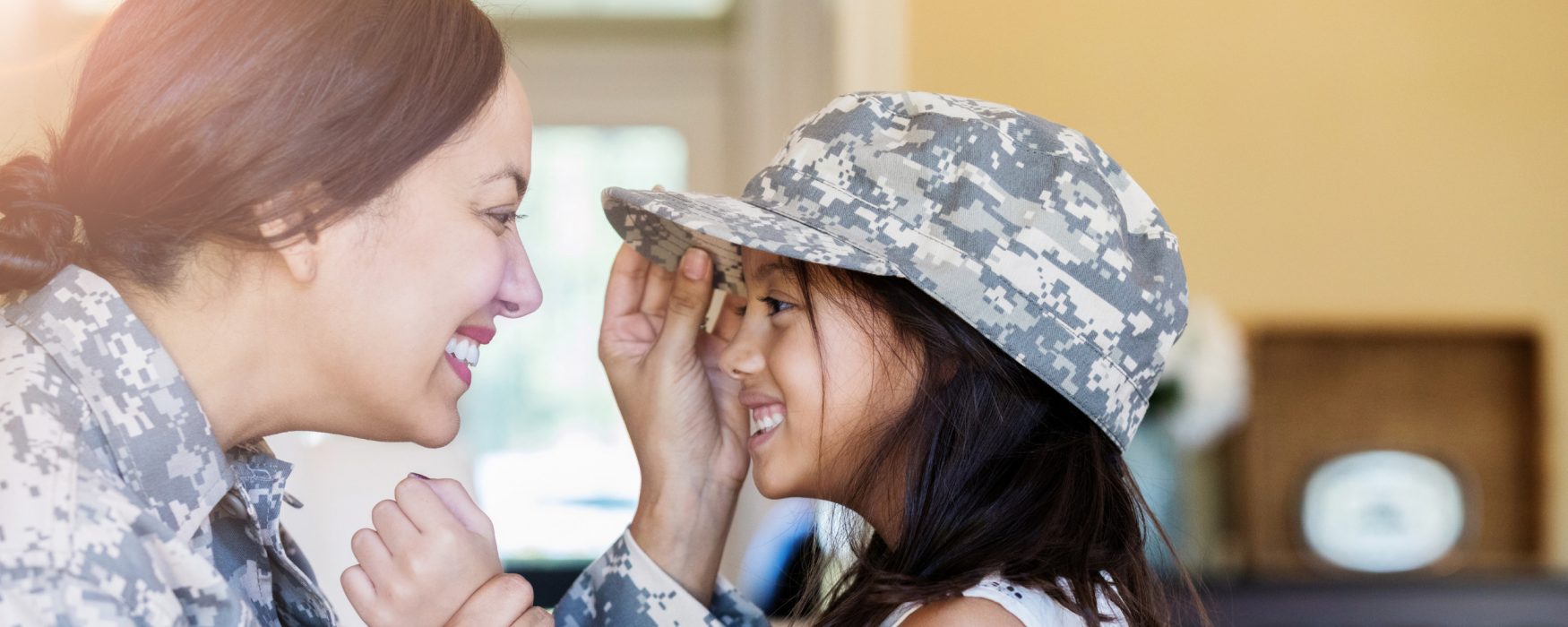 Little girl wearing military mom's hat