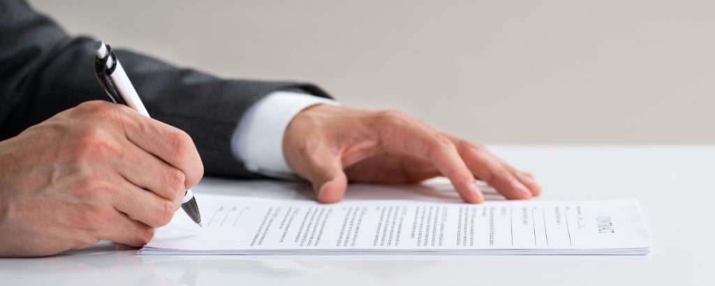 Person signing a legal document