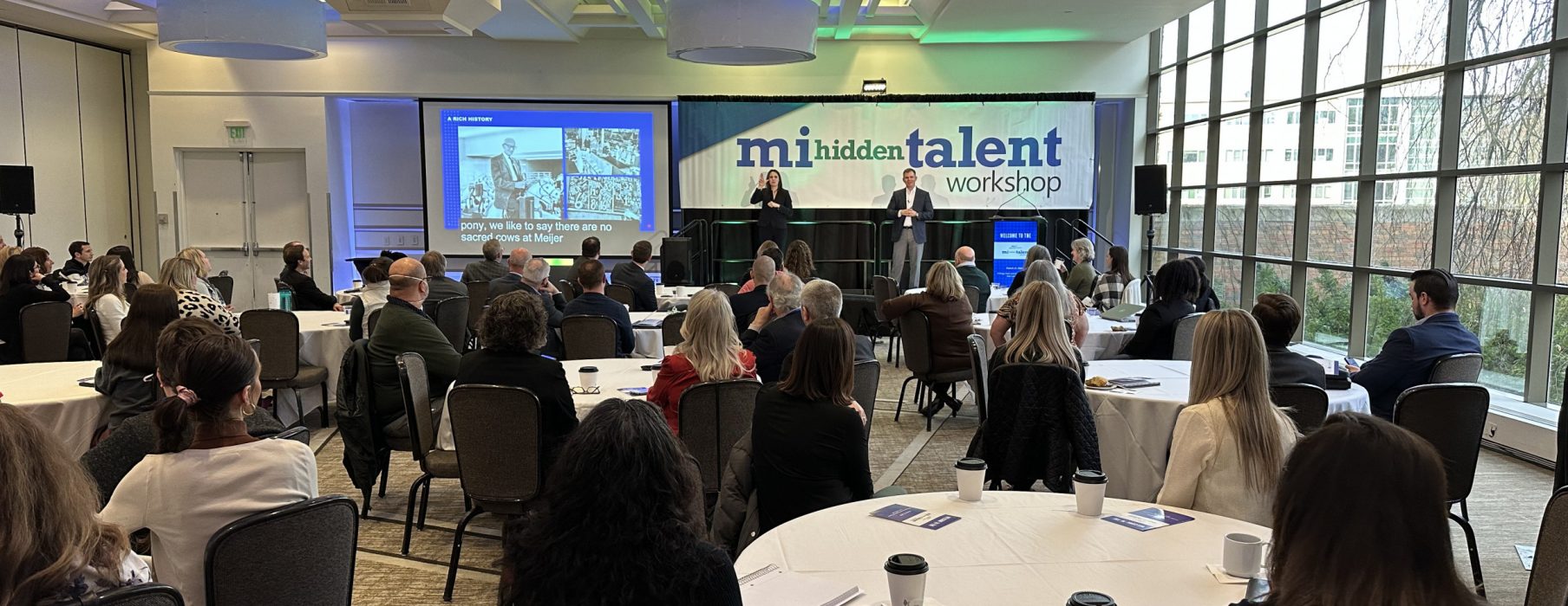 Attendees at the MI Hidden Talent workshop sit at tables and listen to Rick Keyes present.