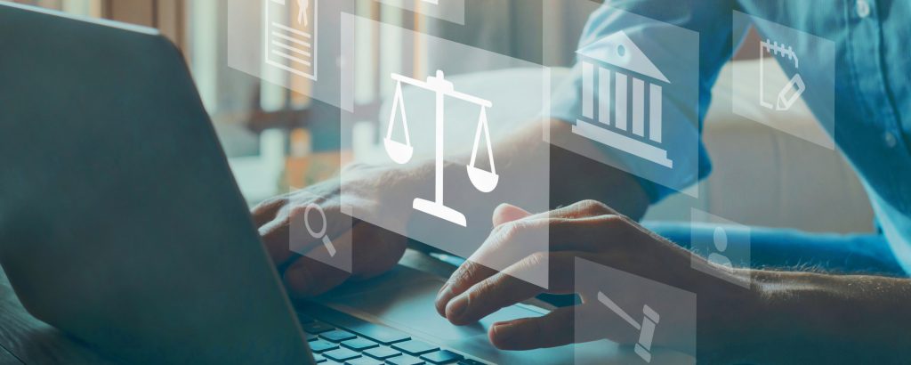 A man's hands hover over a laptop keyboard with an overlaid graphic of images representing law