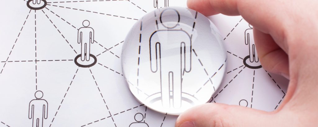 Magnifying glass held over an image of a person