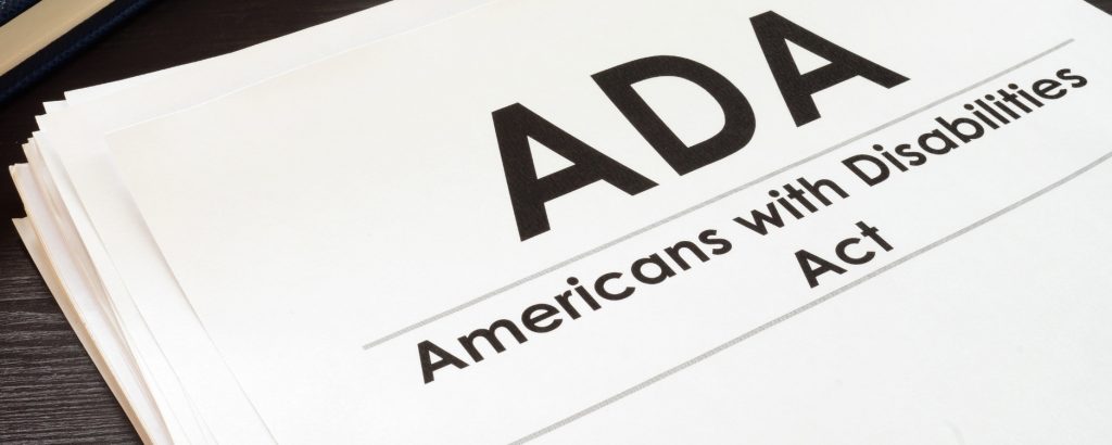 Image of papers on a desk titled ADA, Americans with Disabilities Act