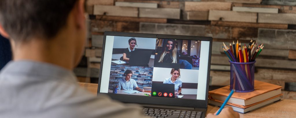 Image of person working remotely and participating in an online meeting