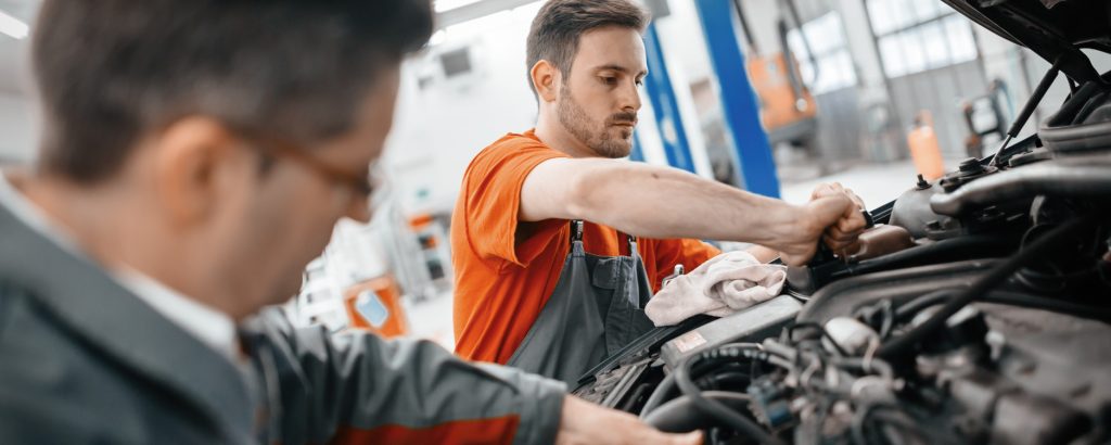 Image of men working on a vehicle