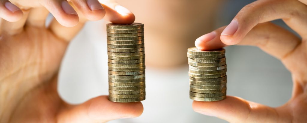 Image of unequal stacks of coins illustrating pay equity