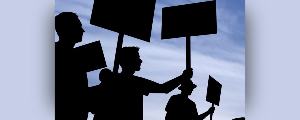 Silhouettes of people on strike and holding signs