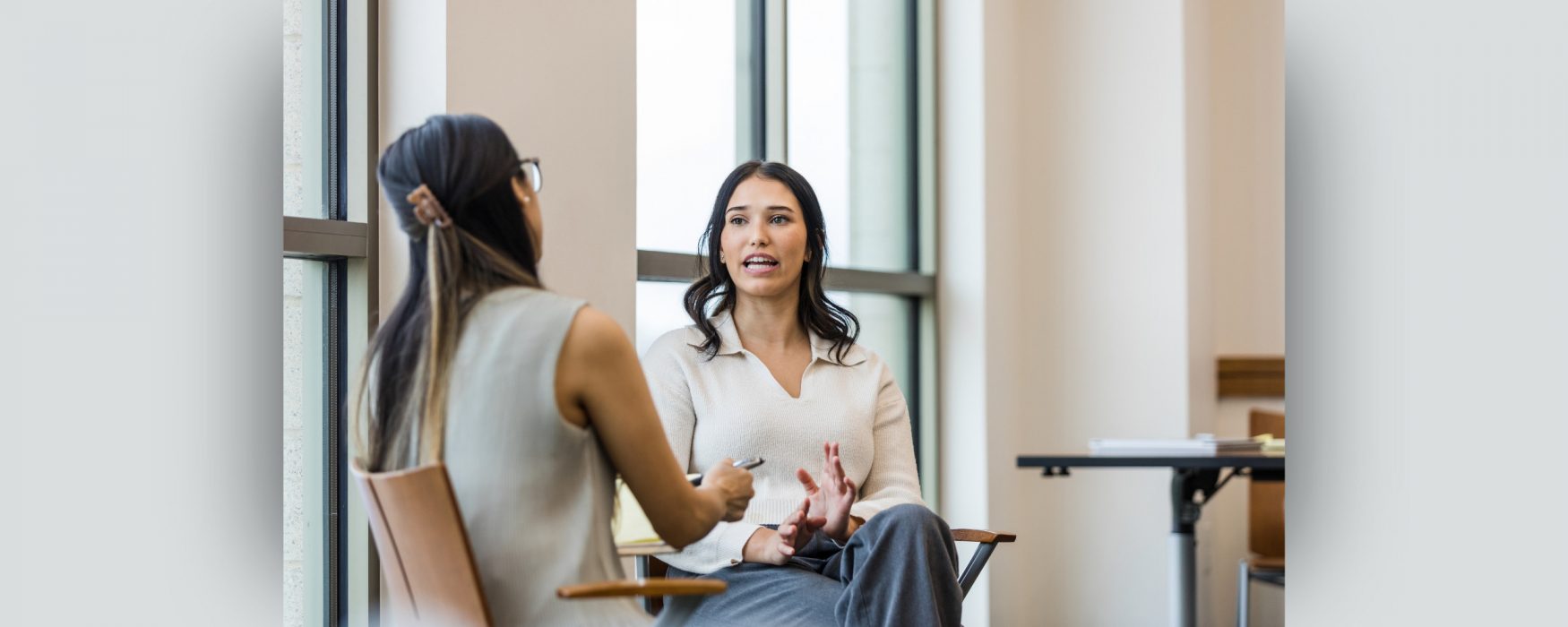 Photo of two employees talking during a check-in