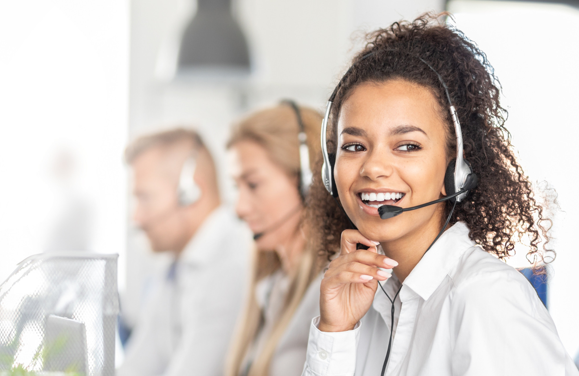 Smiling woman wearing a headset ready to take your customer service call.