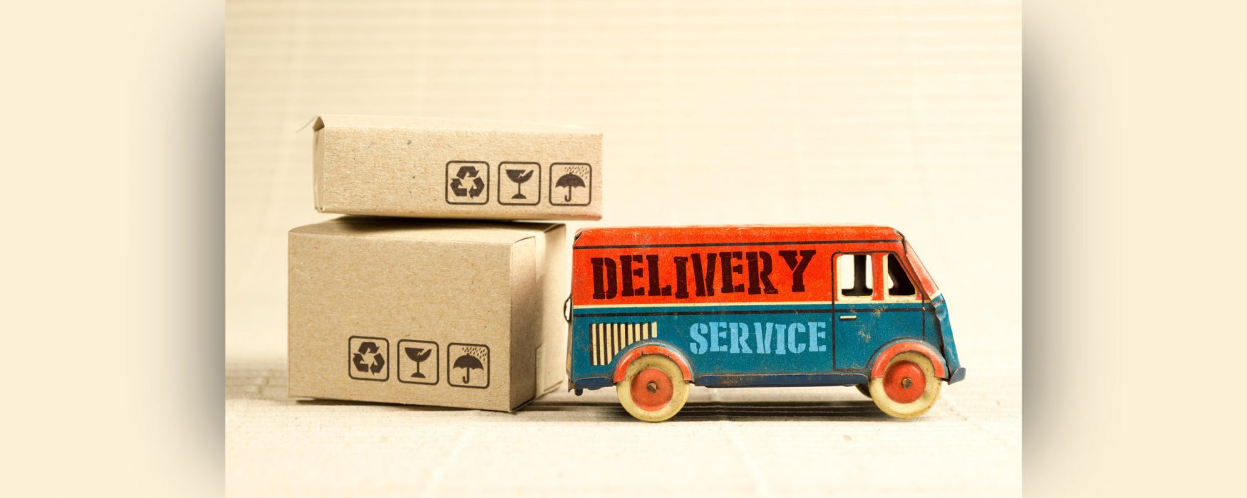 Image of a toy delivery truck sitting with two packages