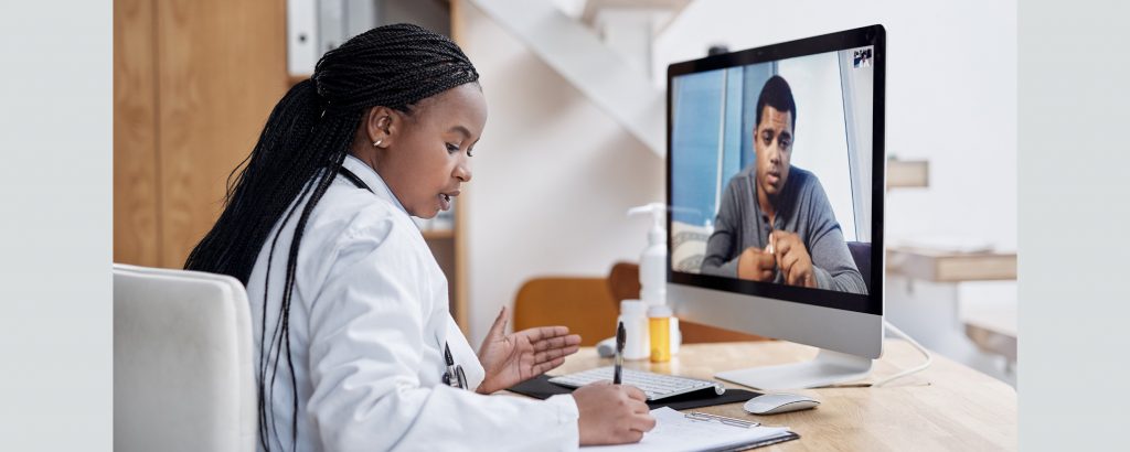 A doctor speaks to a patient on a video call.
