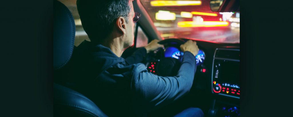Image of a person driving at night