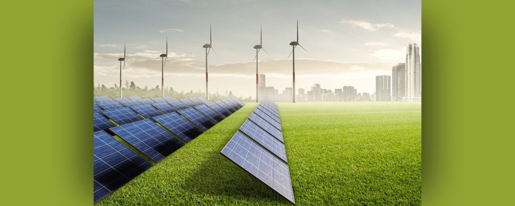 Image of field outside a city with wind turbines and solar panels
