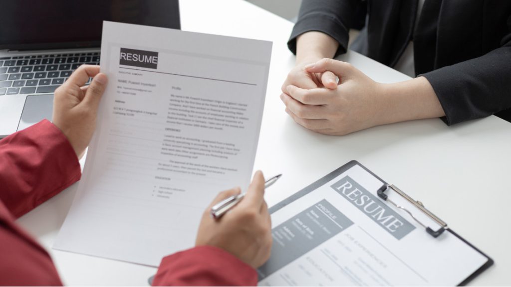 Image of a person holding a resume while interviewing
