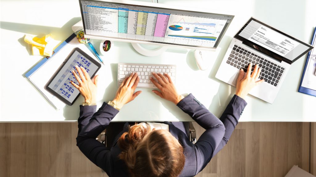 Image of a person multi-tasking on several devices at once