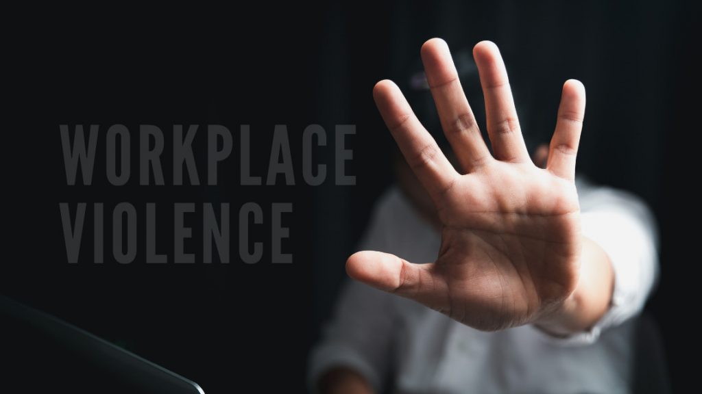 Image of someone holding up there hand in a stop workplace violence gesture