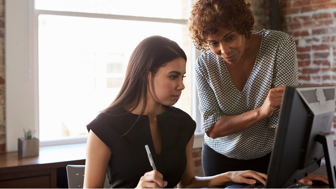 Two people in the workplace demonstrating a coaching culture