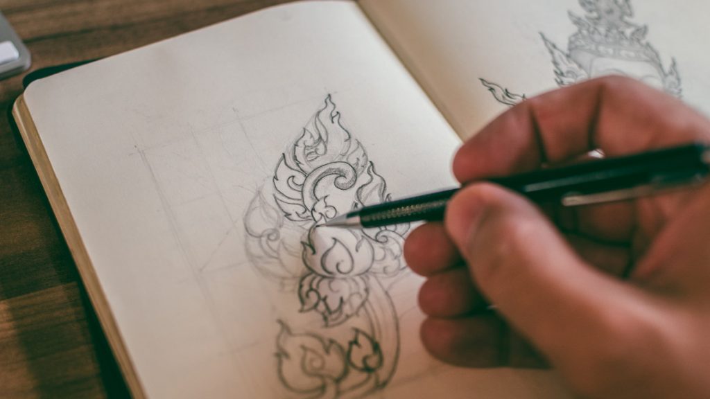 A person doodling in a notebook
