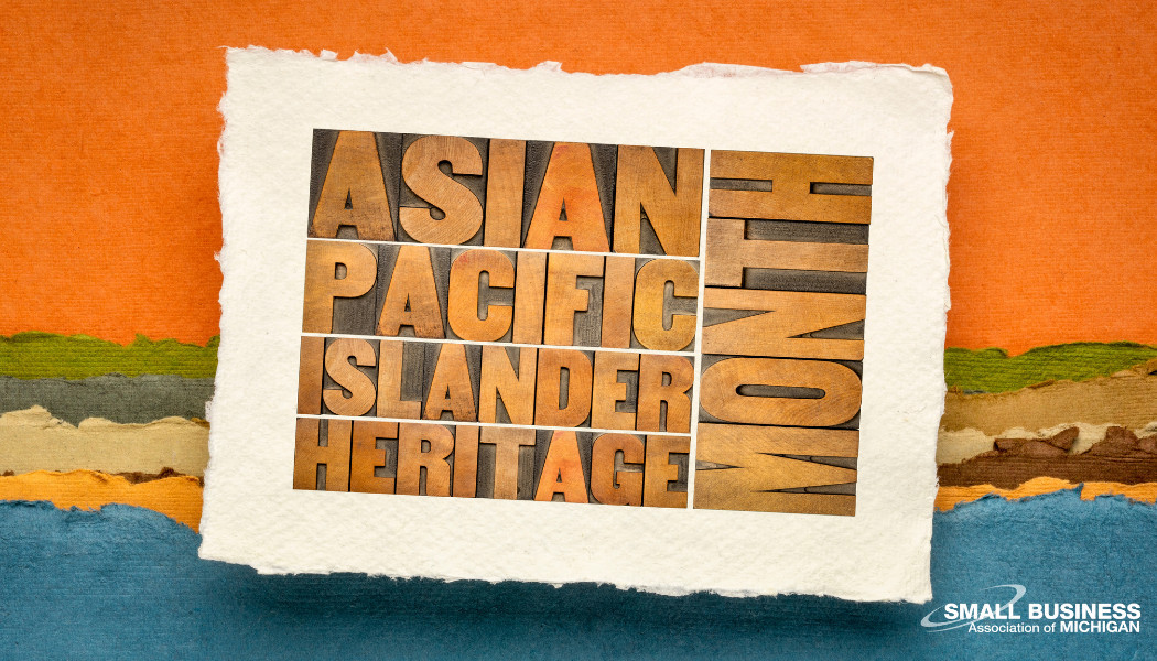 Block text reading Asian Pacific Islander Heritage Month with an orange and blue background