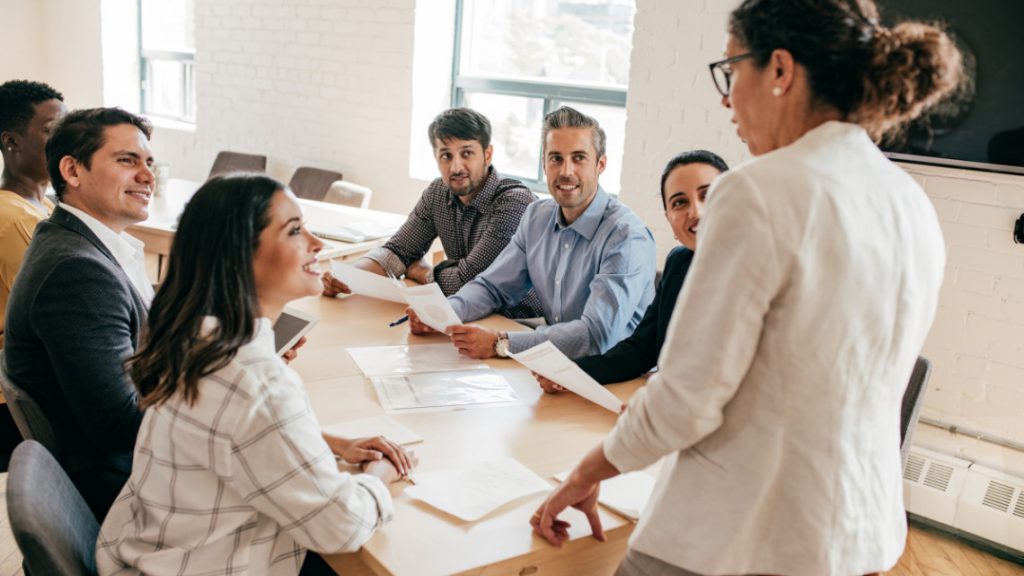 Group of employees and leadership around a table, workplace culture