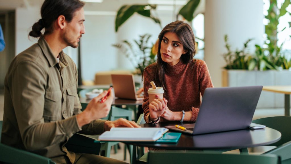 people engaged in a one-on-one meeting