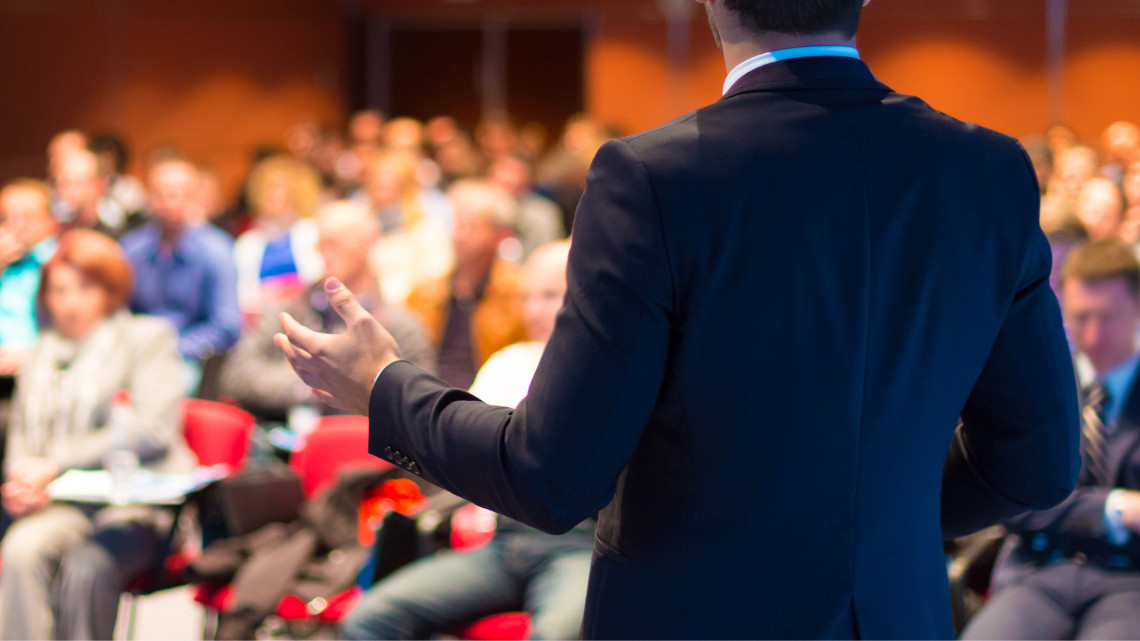 placeholder image of a candidate speaking at a conference