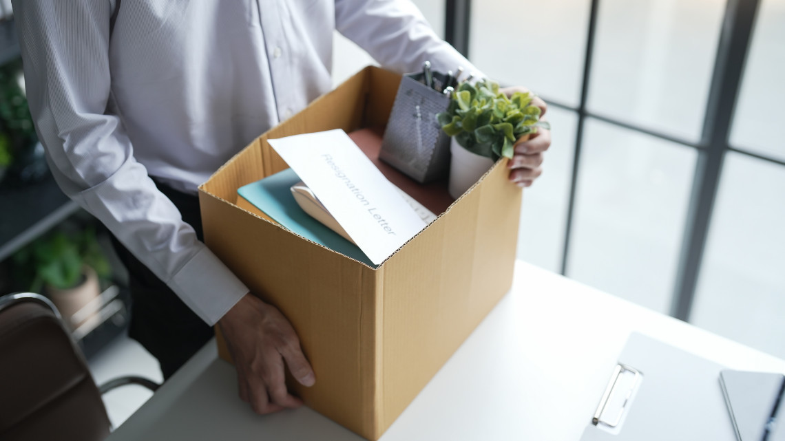 employee leaving with box of belongings