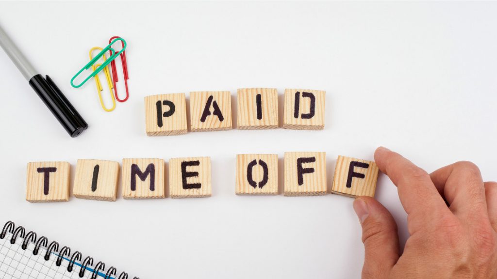 pto, the words paid time off spelled out on wooden scrabble tiles