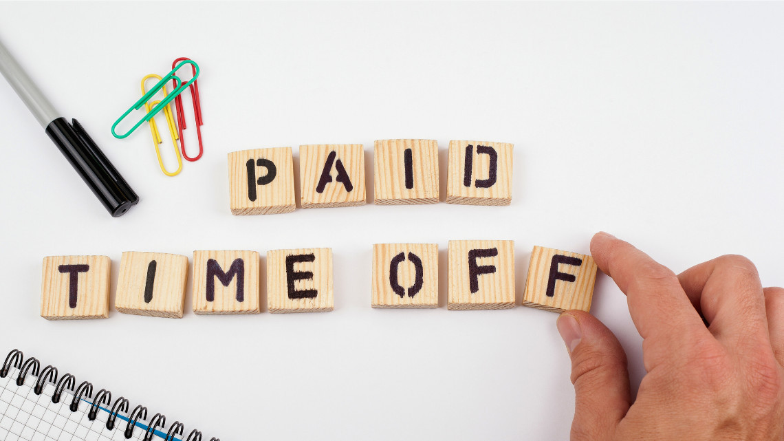 pto, the words paid time off spelled out on wooden scrabble tiles