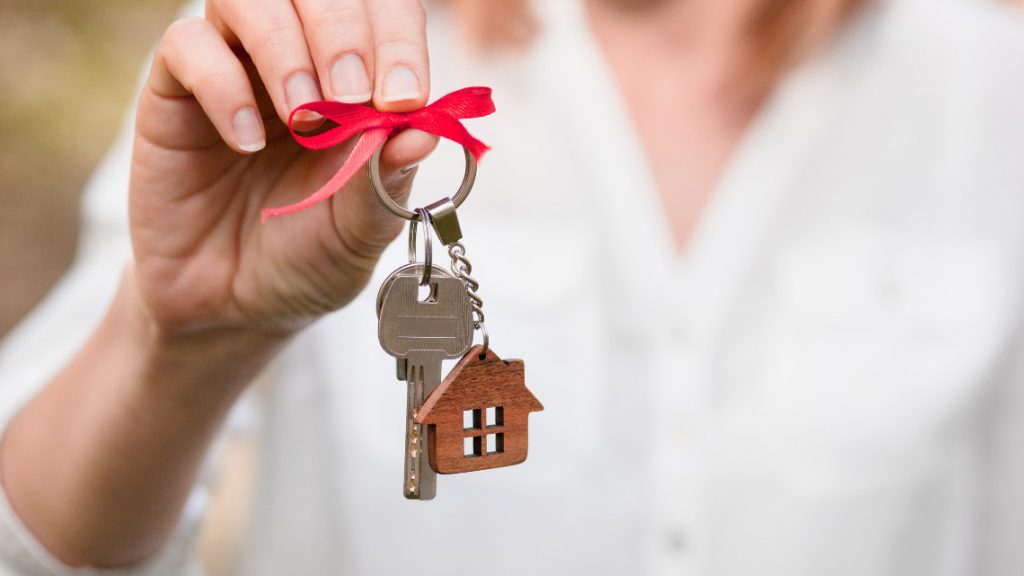 Woman holding keys to new home.