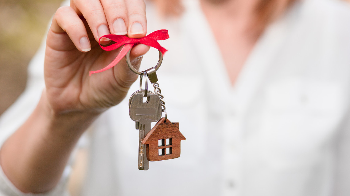 Woman holding keys to new home.