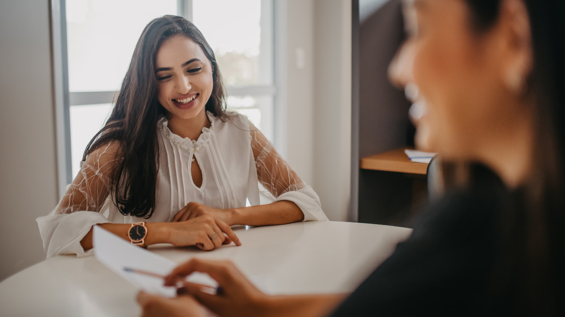 Woman talking with job recruiter for employment.
