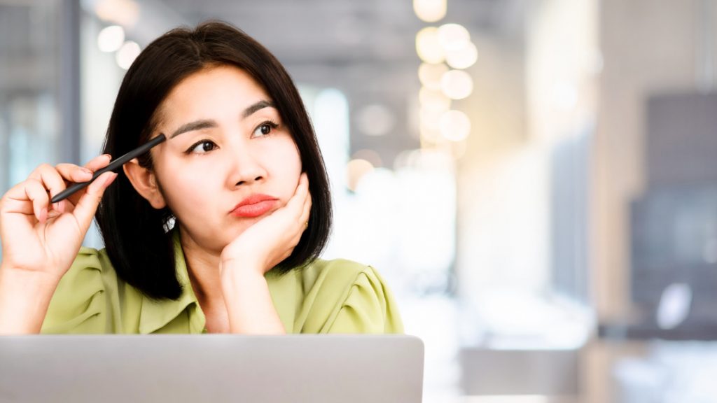 Woman thinking about stepping up in bosses place.