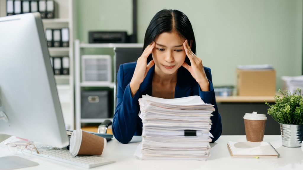 Exhausted employee at her desk.
