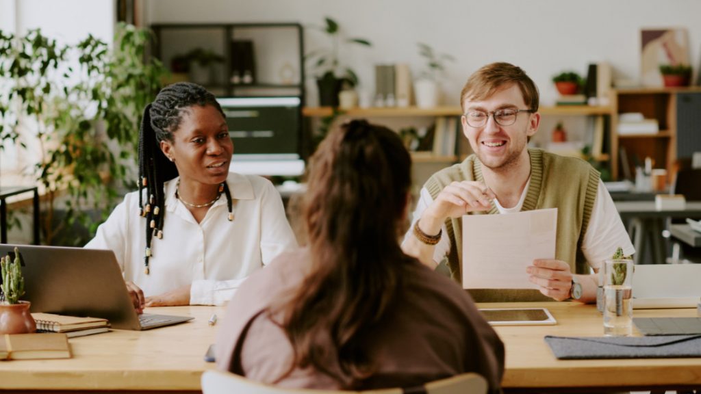 Employees interviewing a woman to be hired.