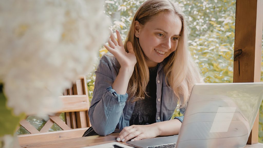 Woman working remotely from home on a video call.