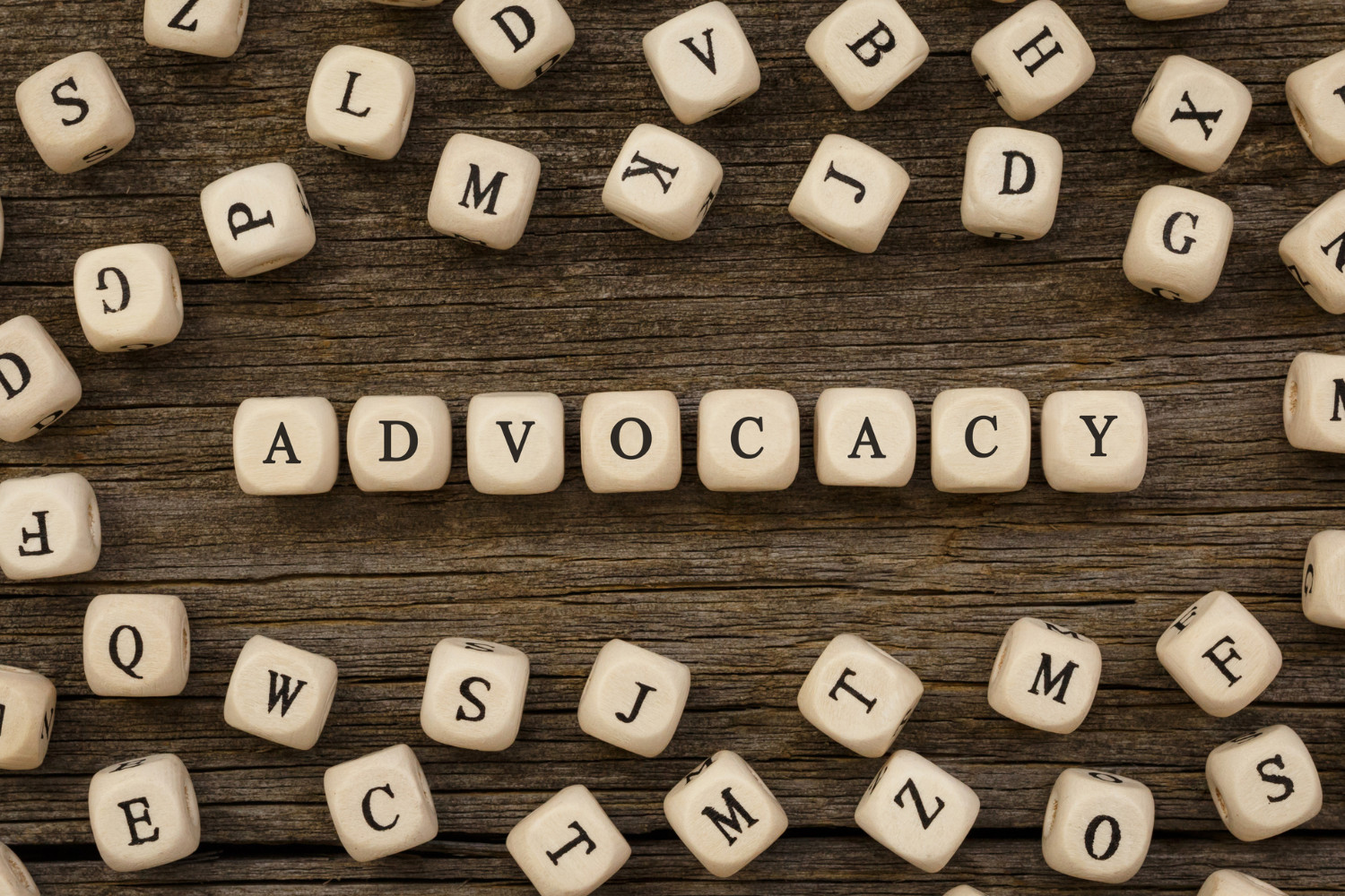 the word advocacy spelled out in scrabble tiles
