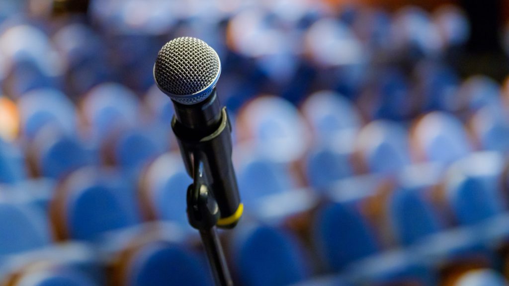 microphone representing the El-Sayed Stevens debate