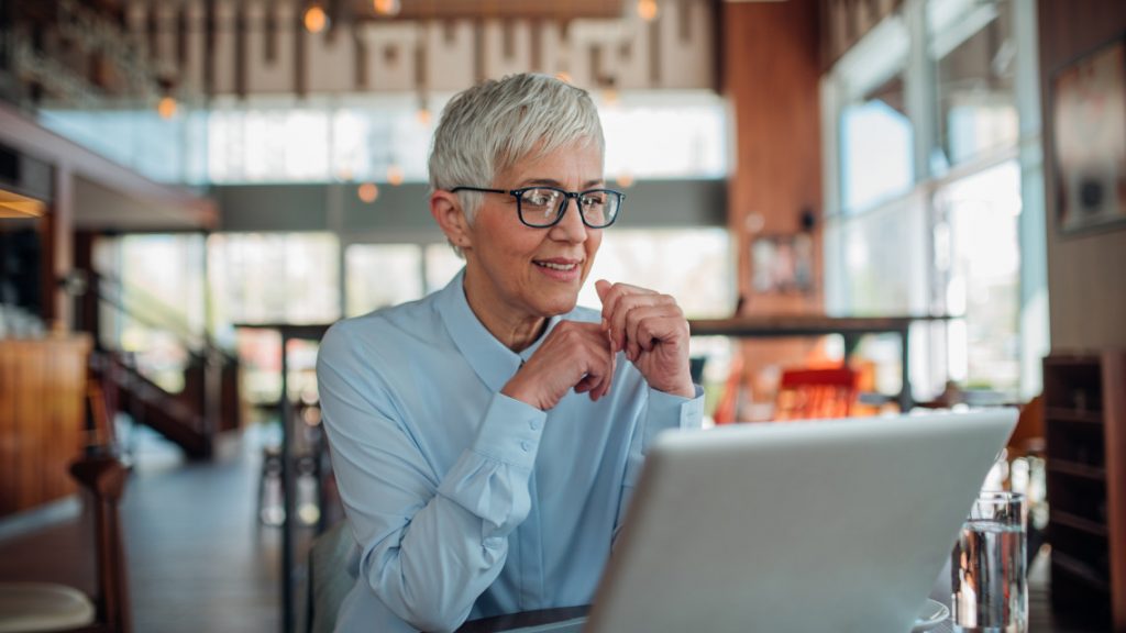 older woman working at computer.