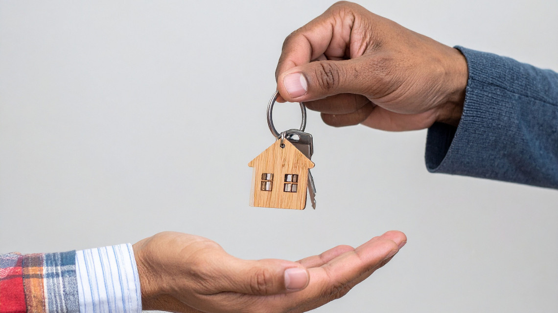 man handing over keys for homeownership