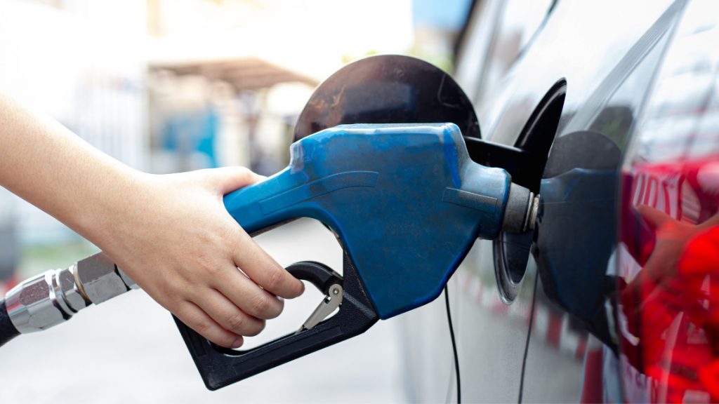 person at the gas pump for article on the gasoline tax